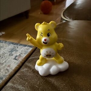 Cheerful Yellow Bear Action Figure on Cloud